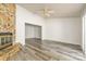 An airy living room featuring a stone fireplace and vinyl flooring at 7129 Stonington Ln, Charlotte, NC 28227