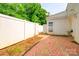 A fenced backyard with a brick patio and access to the house at 7129 Stonington Ln, Charlotte, NC 28227