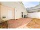 A backyard with a concrete block patio and a white door leading into the home at 7129 Stonington Ln, Charlotte, NC 28227