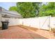 A backyard patio area with an ornate tile flooring and a white privacy fence at 7129 Stonington Ln, Charlotte, NC 28227