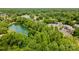 Aerial view of the community pond with fountains surrounded by trees at 7129 Stonington Ln, Charlotte, NC 28227