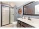 Updated bathroom featuring a glass shower enclosure, modern vanity, and stylish fixtures at 7318 Agnew Dr, Charlotte, NC 28278