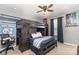 This bedroom features a unique bunk bed, a ceiling fan, and sports-themed décor at 7318 Agnew Dr, Charlotte, NC 28278