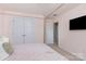 This bedroom features a closet, a ceiling fan, and a view into an adjoining room at 7318 Agnew Dr, Charlotte, NC 28278