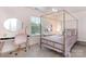 This bedroom offers natural light, a vanity, and a stylish gold bed frame and office chair at 7318 Agnew Dr, Charlotte, NC 28278