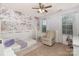This bedroom features a floral accent wall, a loft bed, and natural light from two windows at 7318 Agnew Dr, Charlotte, NC 28278