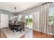 Bright dining room features modern light fixture and sliding door leading to outdoor space at 7318 Agnew Dr, Charlotte, NC 28278