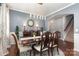 Elegant dining room featuring a large table, modern lighting, and sophisticated decor at 7318 Agnew Dr, Charlotte, NC 28278