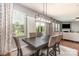 Open-plan dining area adjacent to a living space, featuring a modern chandelier and ample seating at 7318 Agnew Dr, Charlotte, NC 28278