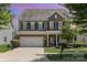 Charming two-story home boasts blue shutters, brick accents, and a well-manicured front lawn at 7318 Agnew Dr, Charlotte, NC 28278