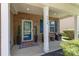 Inviting front porch featuring cozy seating, decorative plants, and a stylish entrance at 7318 Agnew Dr, Charlotte, NC 28278