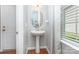 Charming powder room features a pedestal sink and modern fixtures at 7318 Agnew Dr, Charlotte, NC 28278