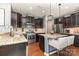 Modern kitchen with a central island, pendant lighting, and stainless steel appliances at 7318 Agnew Dr, Charlotte, NC 28278