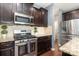 Kitchen boasting stainless steel appliances, dark cabinets and granite countertops at 7318 Agnew Dr, Charlotte, NC 28278