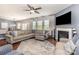 Spacious living room with a fireplace, large sectional sofa, and ample natural light at 7318 Agnew Dr, Charlotte, NC 28278