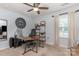 This home office has a ceiling fan, large window, and sleek desk and storage solutions at 7318 Agnew Dr, Charlotte, NC 28278
