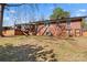 Back exterior of brick house, including a wooden deck, a small sunroom, and a lawn at 851 Gist Rd, Rock Hill, SC 29732