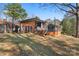 Modern backyard featuring a wooden deck, grill, and unique fence accents, complemented by green lawn space at 851 Gist Rd, Rock Hill, SC 29732