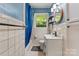 Cozy bathroom features a tub, white tiled walls, and decorative accents at 851 Gist Rd, Rock Hill, SC 29732