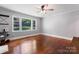 A bright and airy bedroom featuring hardwood flooring, large windows, and a ceiling fan at 851 Gist Rd, Rock Hill, SC 29732