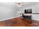 An empty bedroom featuring gleaming hardwood floors, ceiling fan, and a mounted television at 851 Gist Rd, Rock Hill, SC 29732