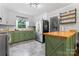 Bright kitchen featuring stainless steel appliances, butcher block countertops, and green cabinets at 851 Gist Rd, Rock Hill, SC 29732