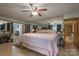 Spacious bedroom with a king bed, decorative mirror wall, and a ceiling fan at 857 Hills Rd, Belmont, NC 28012