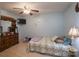 Comfortable bedroom with a decorative dresser, TV, and cozy quilted bedspread at 857 Hills Rd, Belmont, NC 28012