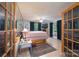 Bright bedroom boasts a decorative rug, stylish furniture, and double french doors at 857 Hills Rd, Belmont, NC 28012