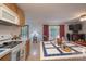 Open kitchen with wood cabinets and island adjoins living area with natural light at 857 Hills Rd, Belmont, NC 28012