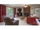 Cozy living room featuring a brick fireplace, large window and comfortable seating at 857 Hills Rd, Belmont, NC 28012
