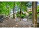 Wooded backyard with a bridge and stone steps, showcasing the lush greenery and surrounding trees at 9075 Blue Ridge Dr, Indian Land, SC 29707