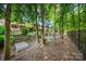 Wooded backyard featuring a bridge, and stairs leading up to the home's outdoor space at 9075 Blue Ridge Dr, Indian Land, SC 29707