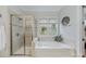 Bright bathroom featuring a separate shower and tub with a window view at 9075 Blue Ridge Dr, Indian Land, SC 29707