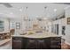 Bright eat-in kitchen features granite counters, stainless appliances, and a large island with seating for easy dining at 9075 Blue Ridge Dr, Indian Land, SC 29707