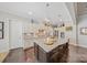 Light and airy kitchen features granite countertops, stainless appliances, and a large island with barstool seating at 9075 Blue Ridge Dr, Indian Land, SC 29707