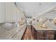Open-concept kitchen offers granite countertops, stainless appliances, and a large island with barstool seating at 9075 Blue Ridge Dr, Indian Land, SC 29707