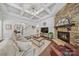 Inviting living room showcasing a stone fireplace, coffered ceilings, and hardwood flooring at 9075 Blue Ridge Dr, Indian Land, SC 29707