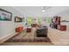Open living room with a large rug, ceiling fan, and view of the backyard at 9075 Blue Ridge Dr, Indian Land, SC 29707