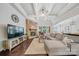 Open-concept living room featuring stone fireplace, coffered ceiling, and ample seating at 9075 Blue Ridge Dr, Indian Land, SC 29707