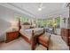 Tranquil main bedroom features a trey ceiling, large windows, and a cozy sitting area for relaxation at 9075 Blue Ridge Dr, Indian Land, SC 29707