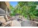 Charming stone patio features a cozy fire pit and ample seating surrounded by lush landscaping at 9075 Blue Ridge Dr, Indian Land, SC 29707