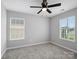 Bright bedroom with large windows offering ample natural light, plush carpeting, and a ceiling fan at 908 Sundance Dr, Gastonia, NC 28054