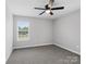 Bedroom showcasing gray walls, soft carpet, a ceiling fan, and a bright window at 908 Sundance Dr, Gastonia, NC 28054