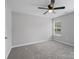 Bright bedroom features gray walls, carpet, a ceiling fan, and a window at 908 Sundance Dr, Gastonia, NC 28054