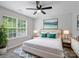 Bright bedroom featuring a ceiling fan, ample natural light, stylish bedside tables, and a modern blue patterned rug at 908 Sundance Dr, Gastonia, NC 28054