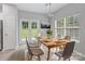 Bright dining room features a wood table, backyard views from french doors, and stylish modern decor at 908 Sundance Dr, Gastonia, NC 28054