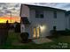Back exterior view featuring outdoor patio and lawn area during sunset at 908 Sundance Dr, Gastonia, NC 28054