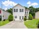 Two-story home with white siding, manicured lawn, and a paved driveway at 908 Sundance Dr, Gastonia, NC 28054
