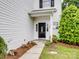 Charming front entrance with black door, welcome mat, and white siding at 908 Sundance Dr, Gastonia, NC 28054